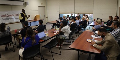 Program Director Dr. Aloja Airewele opening a graduation ceremony with students, families and organizational partner representatives
